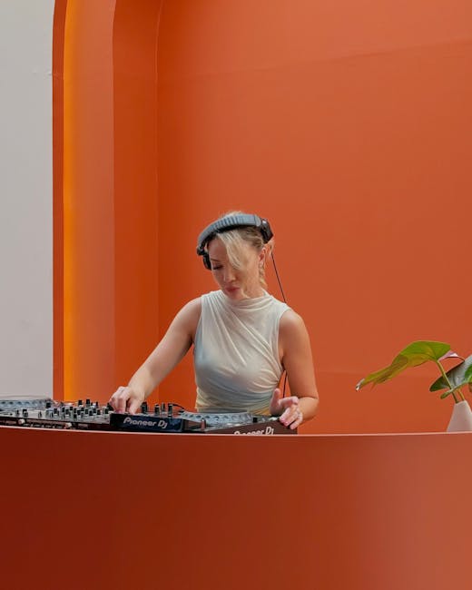 A woman performing as a DJ in a modern setting